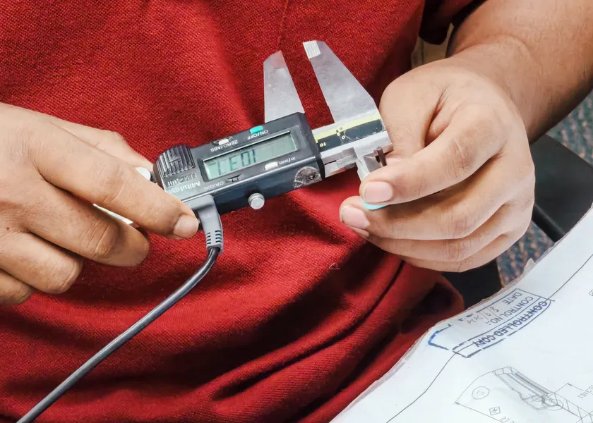 Measuring a part with a caliper