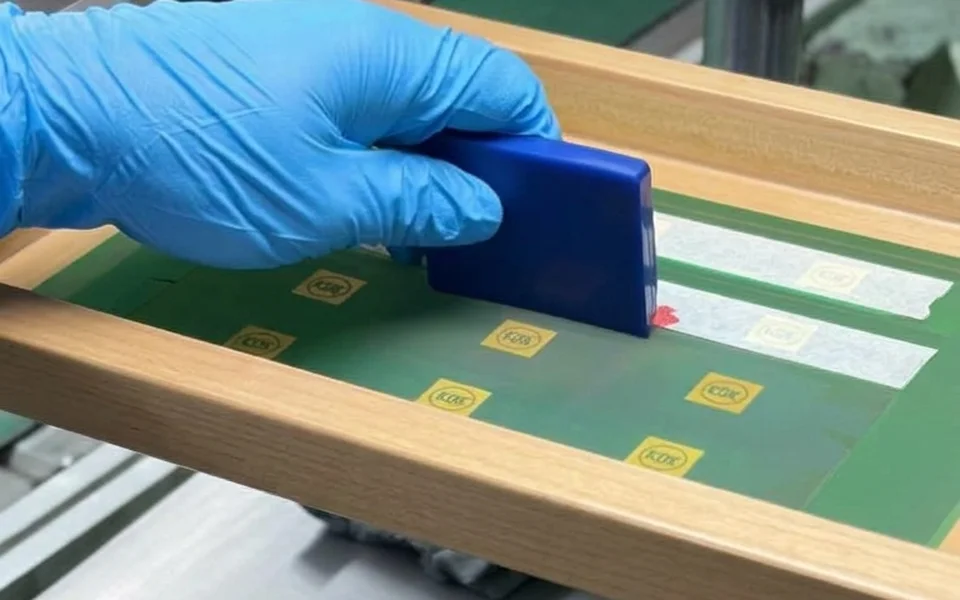 Silk screen printing logos with a squeegee